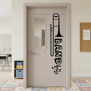BAND wall decal shown across a classroom door window in a school music space.