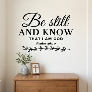 Be Still and Know wall decal shown above a light dresser in a neutral bedroom.