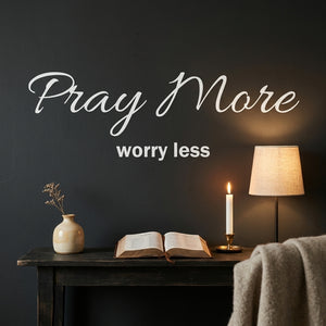 Pray More Worry Less wall decal styled above a console in a dark prayer nook.