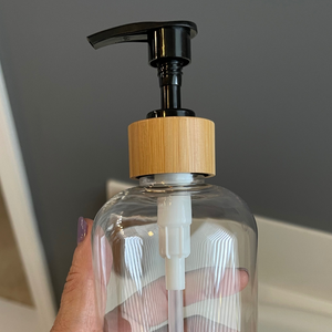 Close up picture of bamboo pump on a clear bottle